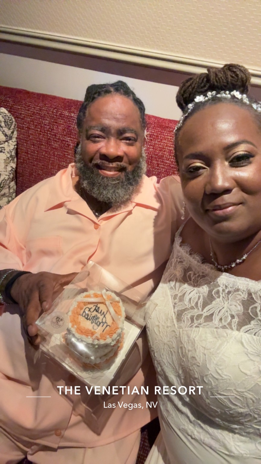 Happy couple holding anniversary cake