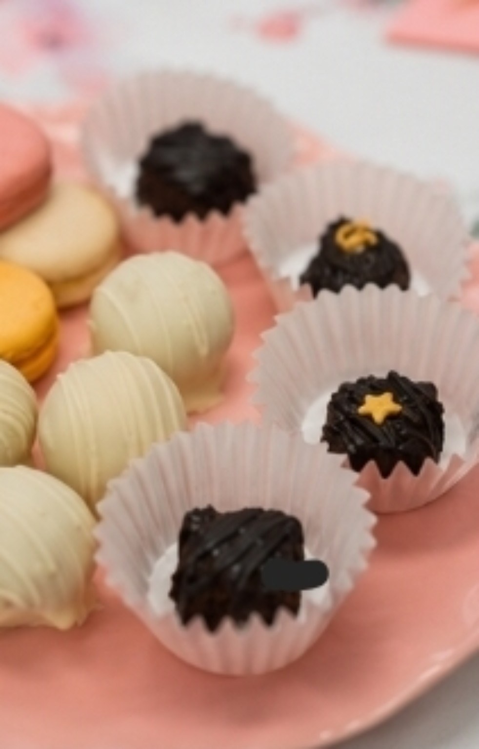 Close-up of handcrafted truffles and macarons